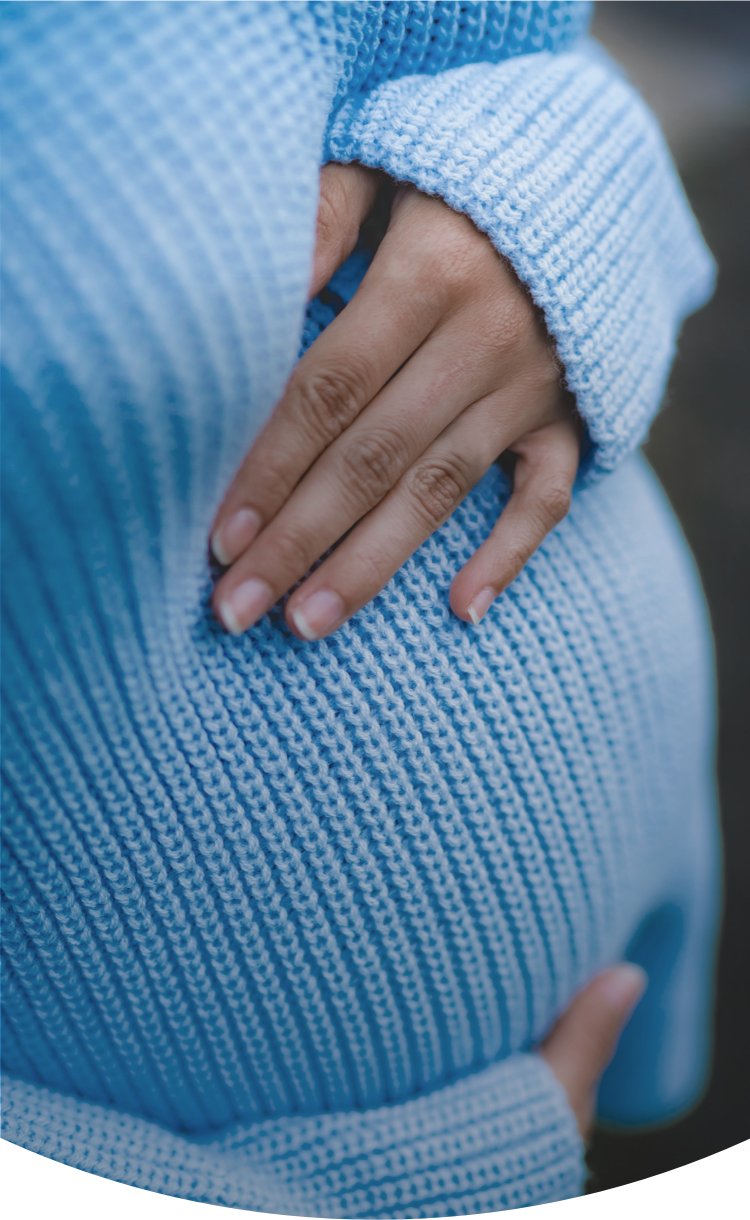 close-up of woman holding her baby bump
